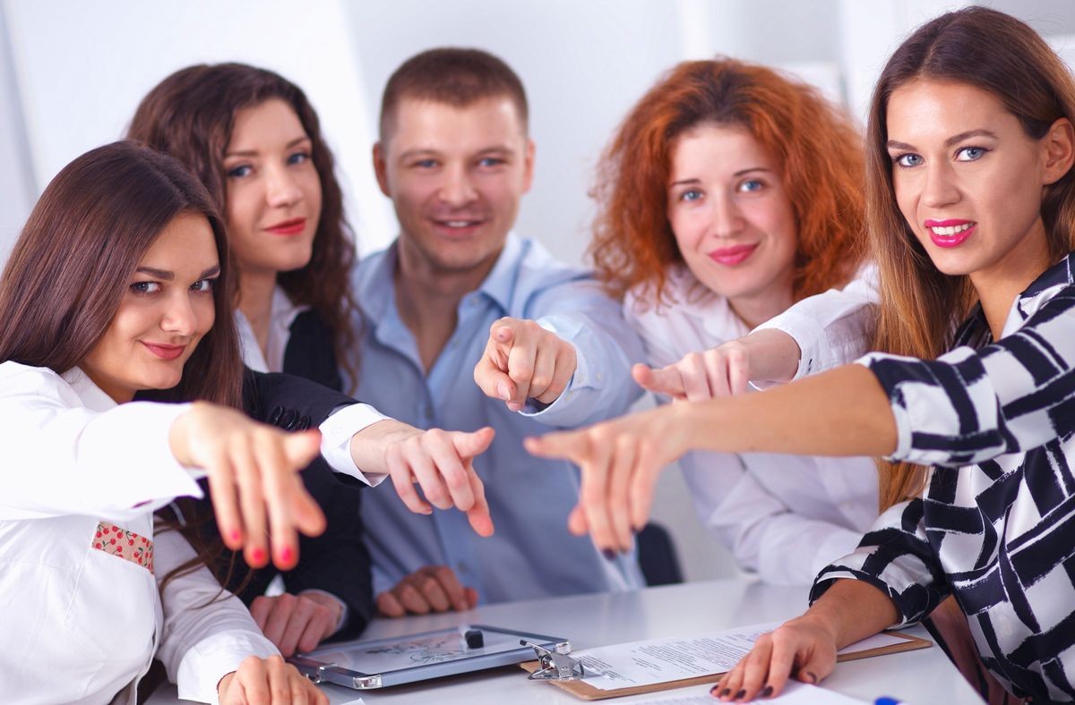 Business people group team point finger at you